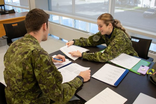 Two cadets studying together in Massey Library